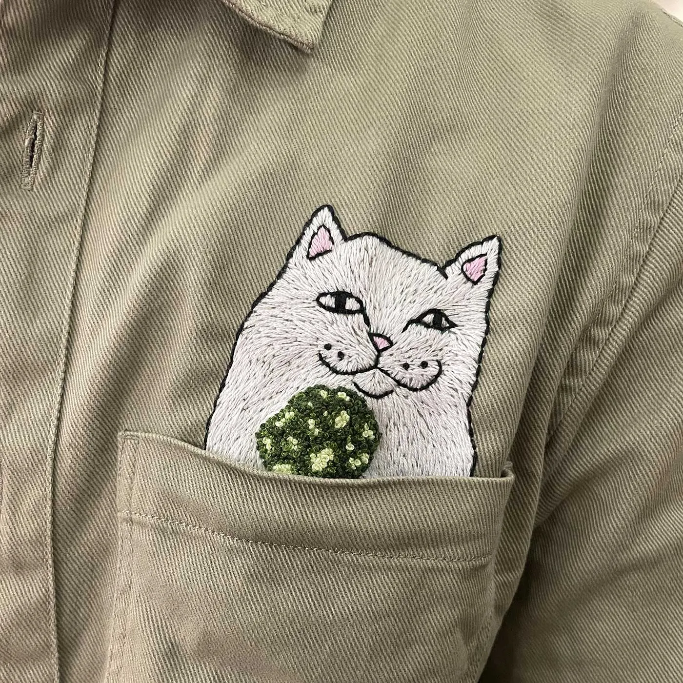 Cat embroidery on a shirt pocket